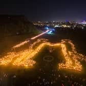 Torch bearers creating the 'Be Together' symbol in Holyrood Park following the annual torchlight procession through Edinburgh for the start of the Hogmanay celebrations in 2019. The event returns this year after it was dropped from the festivities ahead of the 2023 bells. PIC: PA Media.