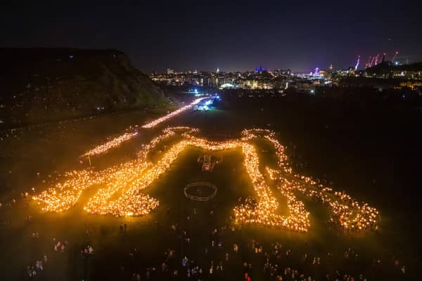 Torch bearers creating the 'Be Together' symbol in Holyrood Park following the annual torchlight procession through Edinburgh for the start of the Hogmanay celebrations in 2019. The event returns this year after it was dropped from the festivities ahead of the 2023 bells. PIC: PA Media.
