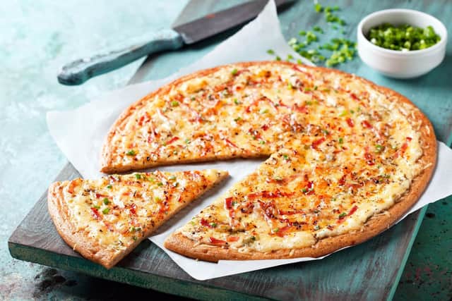 A gluten free pizza with bacon and spring onion.