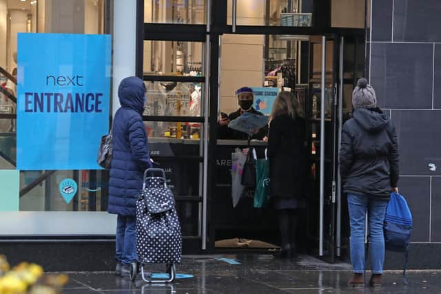 People collect click and collect parcels from Next in Glasgow. Picture: PA Media