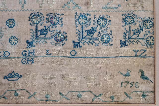 A sampler attributed to Agnes Broun as two rare needlework samplers thought to have been embroidered by Robert Burns's sister and mother, which have been returned to the poet's birthplace. Picture: Peter Devlin/National Trust for Scotland/PA Wire