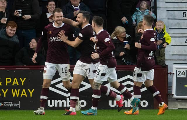 Andy Halliday is mobbed by his team-mates after once again scoring for Hearts.