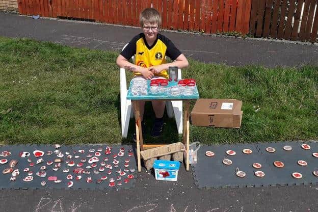 Max Mcdougall selling his homemade poppies.