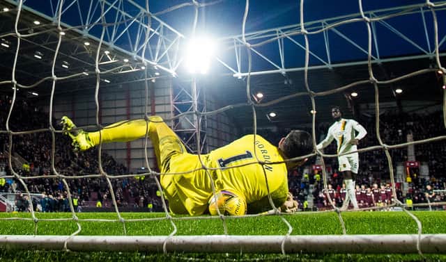 Hearts goalkeeper Craig Gordon saves Ayo Obileye's decisive penalty in the shootout. (Photo by Ross Parker / SNS Group)