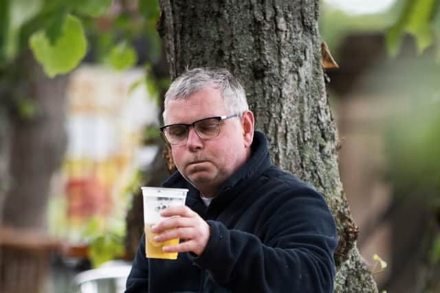 A person drinking at an outdoor beer garden. Nicola Sturgeon has confirmed pubs can reopen in Scotland from 15 July