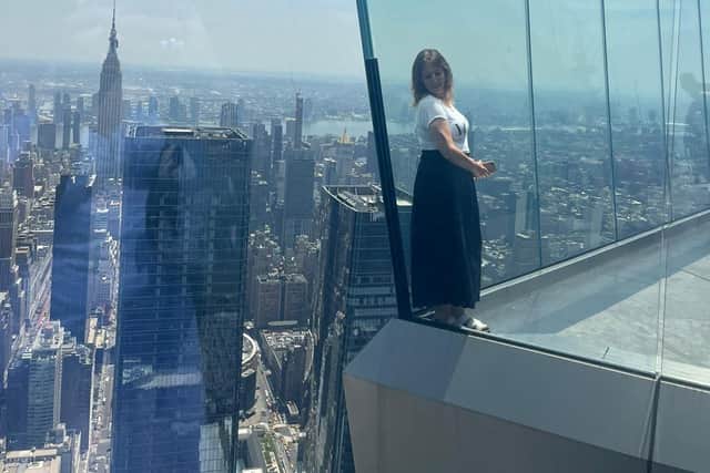 Janet Christie looks down on Manhattan from the 100th floor sky deck which gives the impression of floating in the clouds, at Edge, Hudson Yards, New York. Pic: H Adam