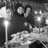 Shopping by candlelight in 1972 when the miners' strike brought power cuts (Picture: George Smith)