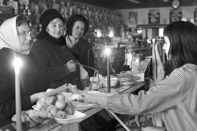 Shopping by candlelight in 1972 when the miners' strike brought power cuts (Picture: George Smith)