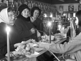 Shopping by candlelight in 1972 when the miners' strike brought power cuts (Picture: George Smith)