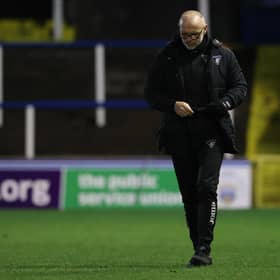 Dunfermline manager John Hughes trudges off the Cappielow pitch.