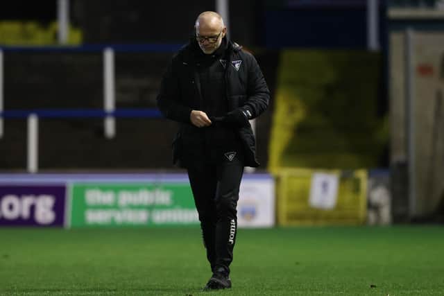 Dunfermline manager John Hughes trudges off the Cappielow pitch.