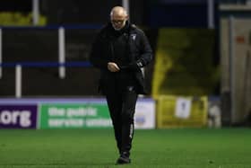 Dunfermline manager John Hughes trudges off the Cappielow pitch.