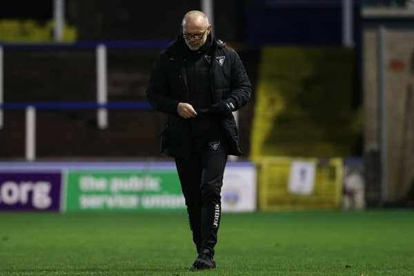 Dunfermline manager John Hughes trudges off the Cappielow pitch.