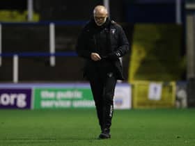 Dunfermline manager John Hughes trudges off the Cappielow pitch.