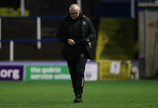 Dunfermline manager John Hughes trudges off the Cappielow pitch.