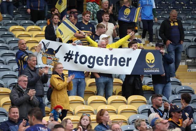Fans of Worcester Warriors hold up a banner saying Together in support of the club during the Gallagher Premiership Rugby match.