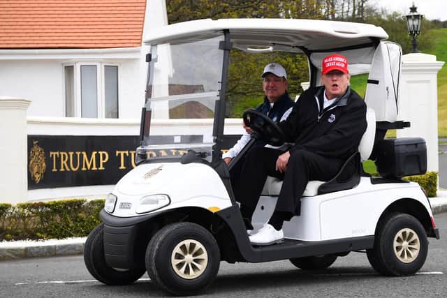 Former US President Donald Trump drives a golf cart at the Trump Turnberry Golf Courses. Picture: Andy Buchanan/AFP via Getty Images