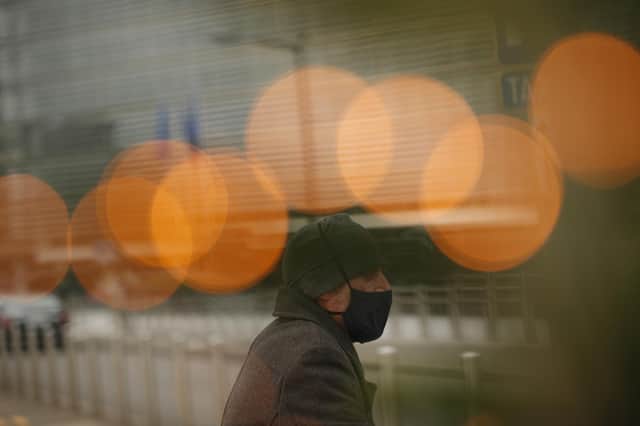 A man in a protective face mask walks past EU headquarters in Brussels prior to a meeting of Britain's chief negotiator David Frost and EU chief negotiator Michel Barnier. Picture: AP Photo/Francisco Seco