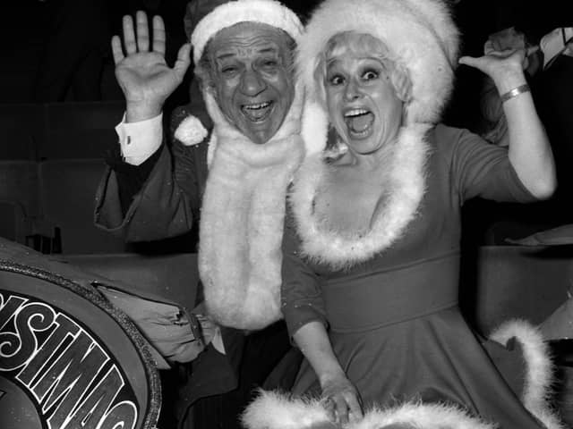 Carry On stars Sid James and Barbara Windsor welcoming guests to a party for ITV's Christmas performers at the New London Theatre.