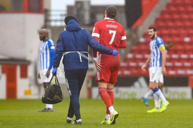 ABERDEEN, SCOTLAND - FEBRUARY 20: Aberdeen's Fraser Hornby is taken off for an injury during a Scottish Premiership match between Aberdeen and Kilmarnock at Pittodrie on February 20, 2021, in Aberdeen, Scotland (Photo by Craig Foy / SNS Group)