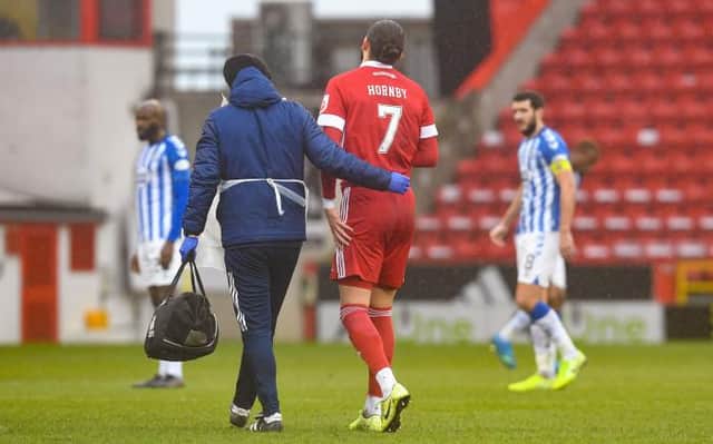 ABERDEEN, SCOTLAND - FEBRUARY 20: Aberdeen's Fraser Hornby is taken off for an injury during a Scottish Premiership match between Aberdeen and Kilmarnock at Pittodrie on February 20, 2021, in Aberdeen, Scotland (Photo by Craig Foy / SNS Group)