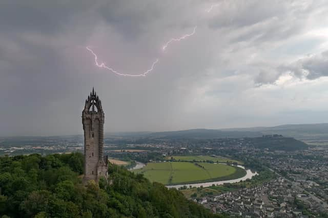 An amateur photographer captured this amazing shot of the moment a lightning strike hit above the Wallace Monument. Picture: Thomas Lamont/SWNS