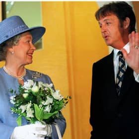 Ex-Beatle Paul McCartney talks with The Queen as she leaves the Liverpool Institute for Performing Arts June 7 1996