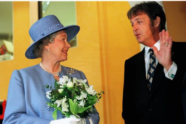 Ex-Beatle Paul McCartney talks with The Queen as she leaves the Liverpool Institute for Performing Arts June 7 1996
