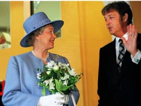 Ex-Beatle Paul McCartney talks with The Queen as she leaves the Liverpool Institute for Performing Arts June 7 1996