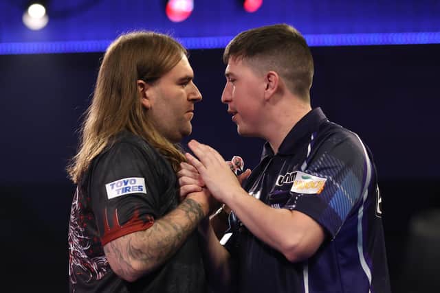 William Borland (right) congratulates Ryan Searle on his second round victory. (Photo by Luke Walker/Getty Images)