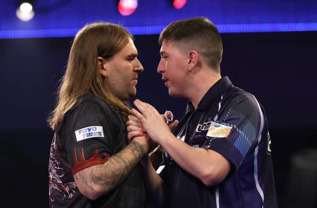 William Borland (right) congratulates Ryan Searle on his second round victory. (Photo by Luke Walker/Getty Images)
