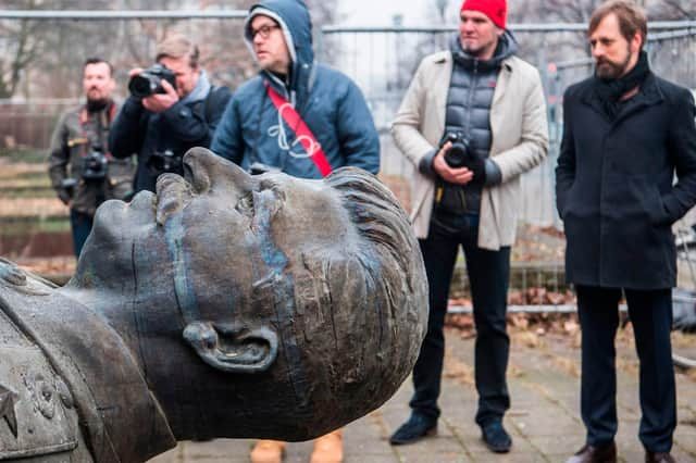 Reporters look on as a statue of former Soviet dictator Joseph Stalin is lifted by a crane on Berlin's Karl-Marx Allee on 23 January, 2018 PIC: John MacDougall / AFP / via Getty Images