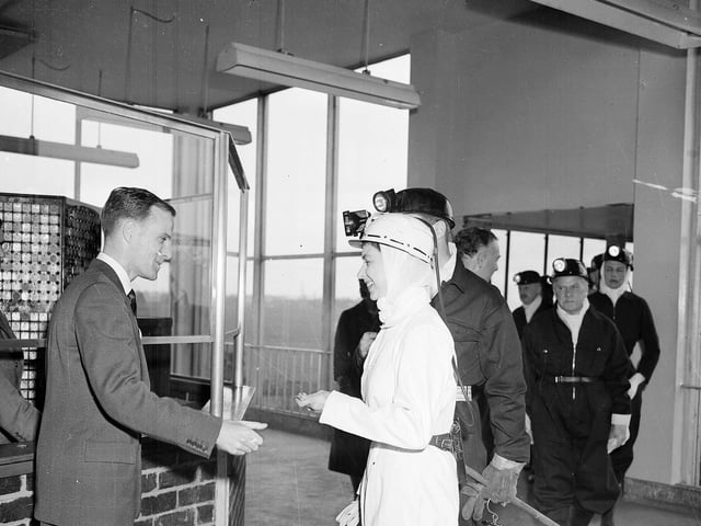 Queen Elizabeth II wears white overalls during a visit to Rothes Colliery, near Kirkcaldy, in June 1958.