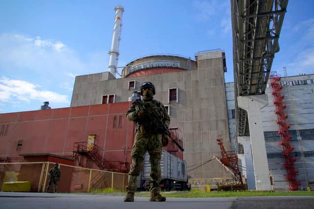A Russian serviceman stands guard at the territory outside the second reactor of the Zaporizhzhia Nuclear Power Station in Energodar. via Getty Images