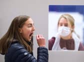 Swab testing as previously done by Edinburgh university students. The new tests will use saliva samples.