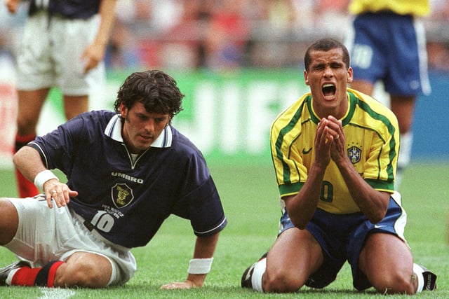 Darren Jackson of Scotland, left, gets up while Rivaldo of Brazil shouts in despair after missing during the opening game of the 1998 World Cup at the Stade de France in St Denis Wednesday, June 10, 1998. Brazil won 2-1.