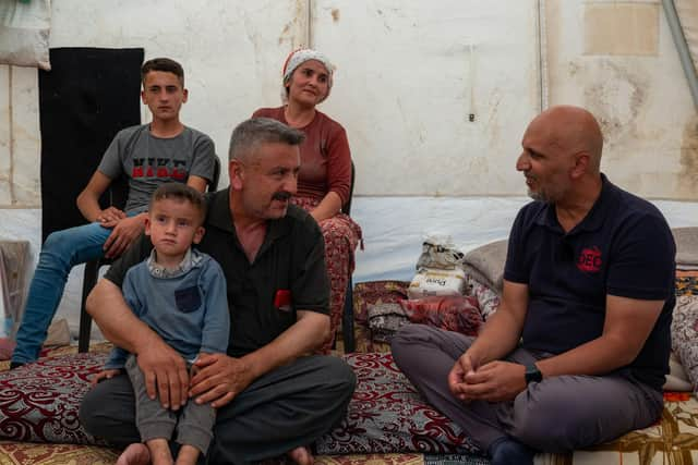 DEC Chief Executive Saleh Saeed meets Zeynep and Mehmet's family who have received cash payments through the British Red Cross as he visits the earthquake response near Gaziantep, Turkey in July.