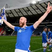 Shaun Rooney holds the Scottish Cup final aloft.