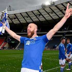 Shaun Rooney holds the Scottish Cup final aloft.