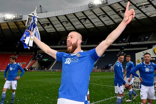 Shaun Rooney holds the Scottish Cup final aloft.