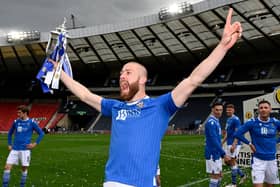 Shaun Rooney holds the Scottish Cup final aloft.