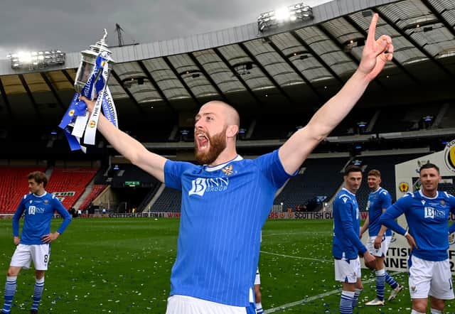 Shaun Rooney holds the Scottish Cup final aloft.