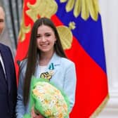 Russian President Vladimir Putin poses with figure skater Kamila Valieva during an awards ceremony for the Beijing 2022 Winter Olympic Games medal winners at the Kremlin in Moscow in April.