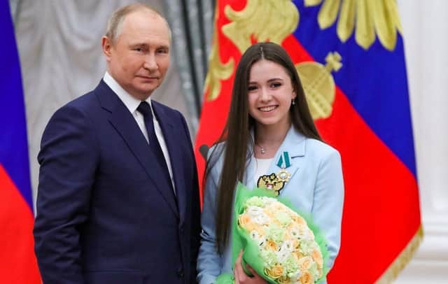 Russian President Vladimir Putin poses with figure skater Kamila Valieva during an awards ceremony for the Beijing 2022 Winter Olympic Games medal winners at the Kremlin in Moscow in April.