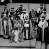 Queen Elizabeth II sits on a throne during her coronation in Westminster Abbey in 1953 (Picture: Central Press Photo Ltd/AFP via Getty Images)