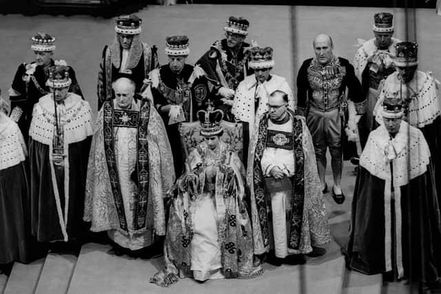 Queen Elizabeth II sits on a throne during her coronation in Westminster Abbey in 1953 (Picture: Central Press Photo Ltd/AFP via Getty Images)