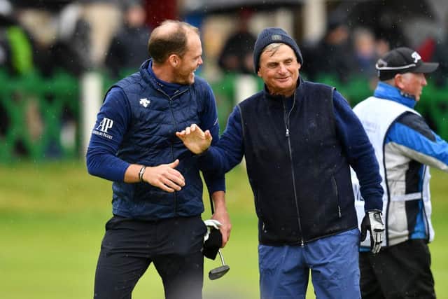Danny Willett shakes hands with playing partner Jimmy Dunne at the end of their round on the Old Course. Picture:  Mark Runnacles/Getty Images.