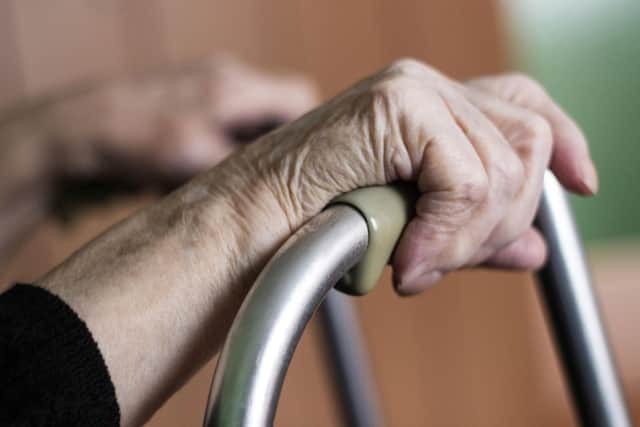 An older person holding onto their walking frame. Picture: PA