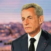 Former French President Nicolas Sarkozy looks on prior to an interview in the evening news broadcast of French TV channel TF1.