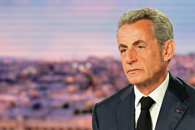 Former French President Nicolas Sarkozy looks on prior to an interview in the evening news broadcast of French TV channel TF1.